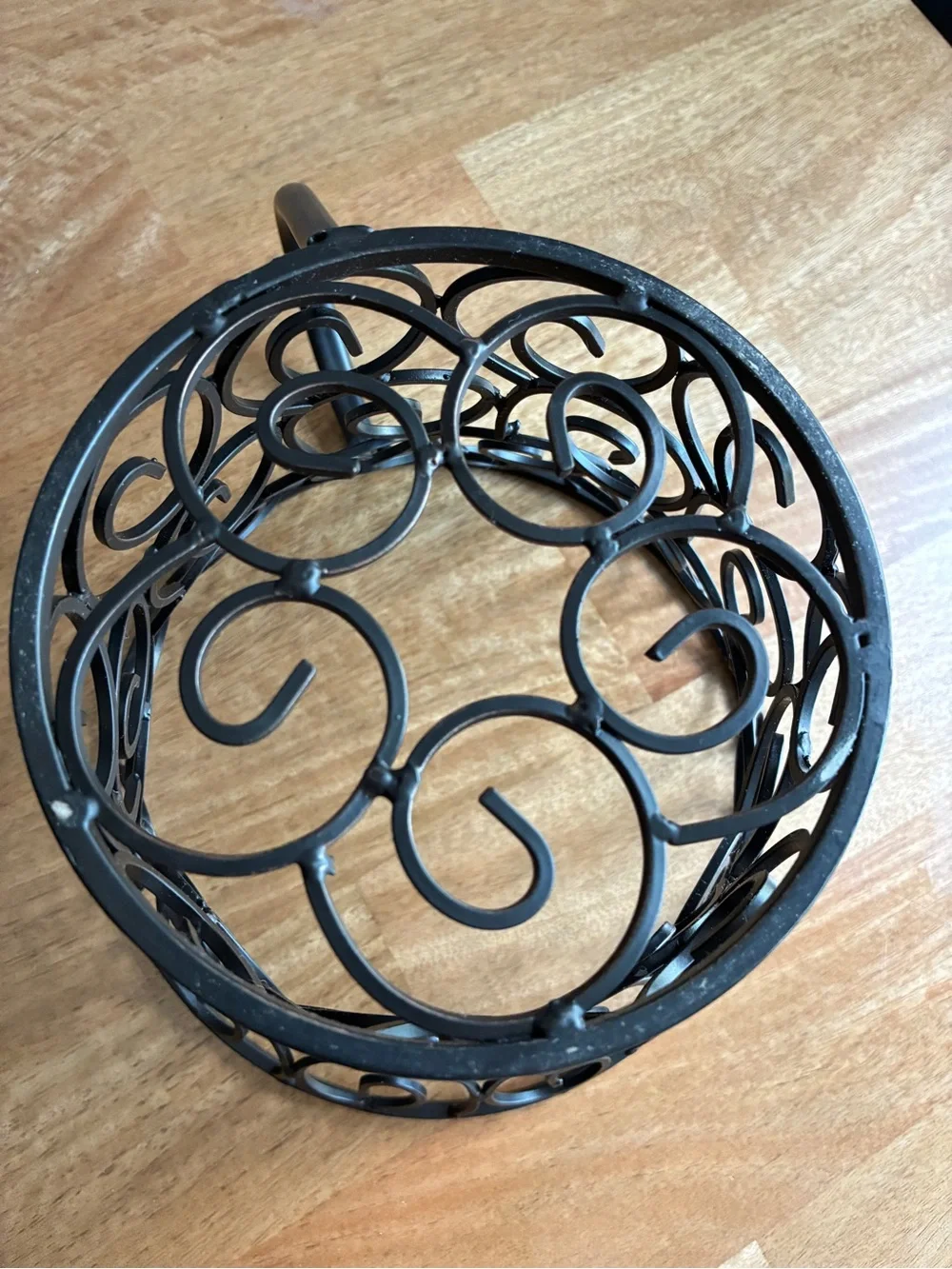wrought iron decorative basket shaped like a large coffee mug or teacup,
